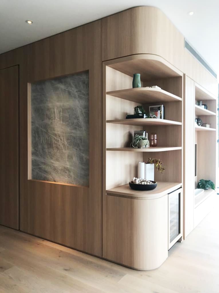 Bespoke curved timber joinery with stone feature panel